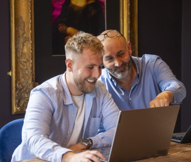 Jack and Simon looking at a laptop