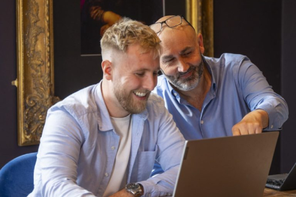 Jack and Simon sharing a laptop