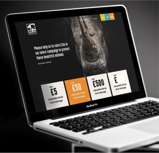 website-page-savetherhino a laptop with a rhinoceros head on the screen - Save the Rhino - a WordPress website
